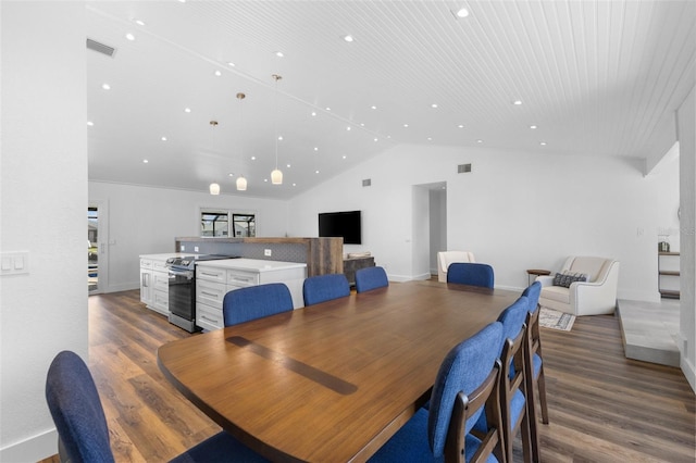 dining area featuring hardwood / wood-style flooring and lofted ceiling