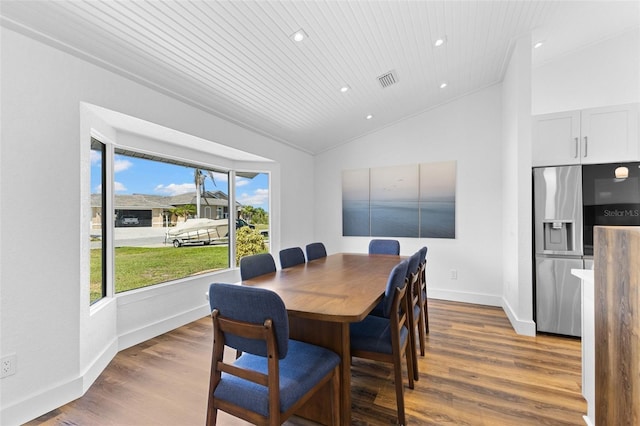 dining space featuring wood ceiling, dark hardwood / wood-style flooring, and vaulted ceiling