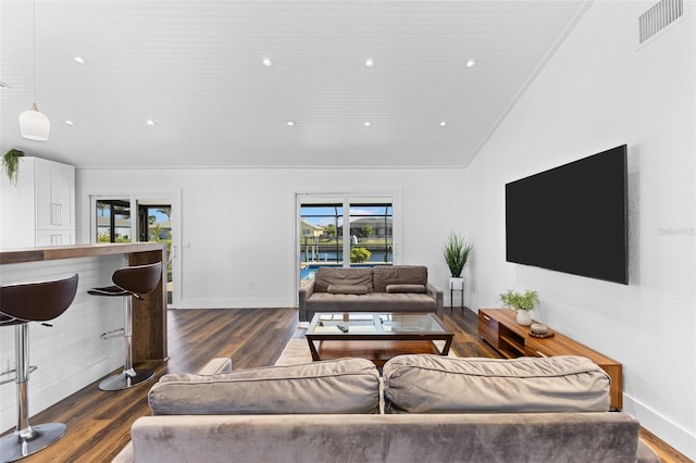 living room featuring dark hardwood / wood-style floors and vaulted ceiling