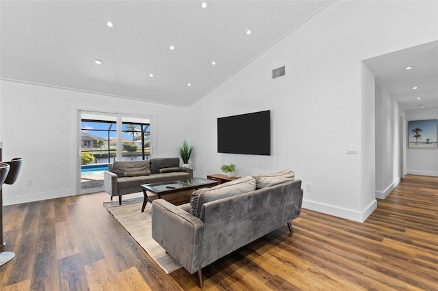 living room featuring dark hardwood / wood-style flooring and high vaulted ceiling