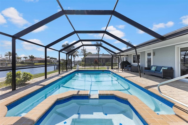 view of pool with a patio area, a water view, glass enclosure, an in ground hot tub, and an outdoor living space