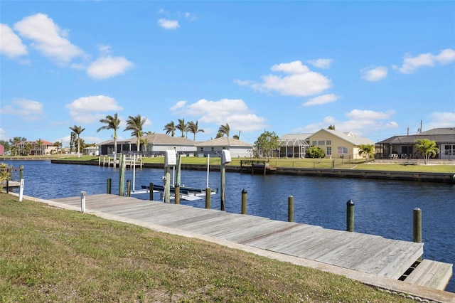 view of dock featuring a water view and a yard