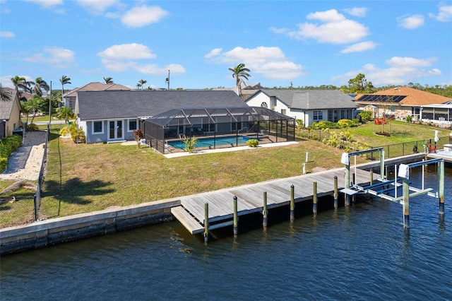 dock area featuring a yard, a water view, and glass enclosure