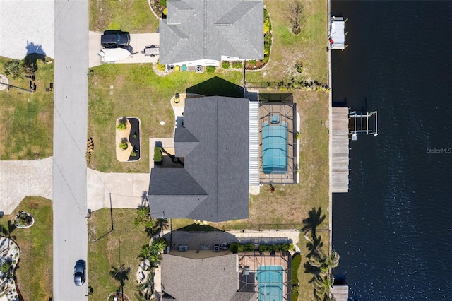 birds eye view of property with a water view