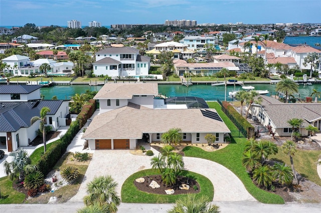 birds eye view of property with a water view and a residential view