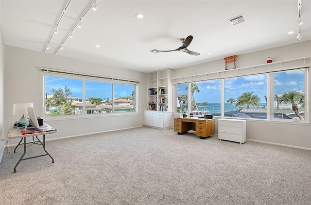 office area with carpet floors, visible vents, a ceiling fan, baseboards, and rail lighting