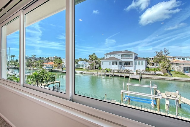 property view of water with a dock, a residential view, and boat lift