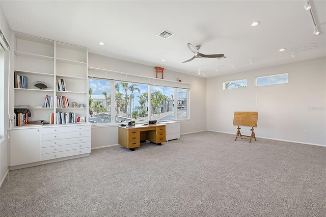 home office featuring light carpet, baseboards, visible vents, ceiling fan, and track lighting