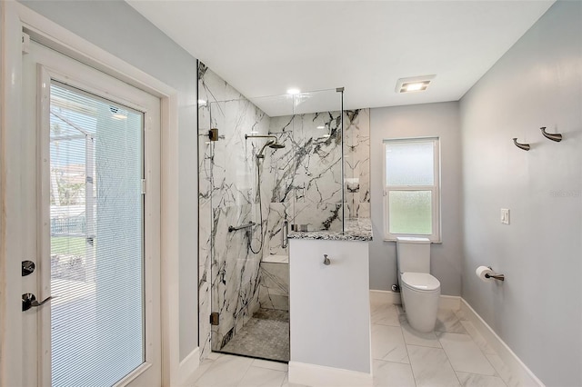 full bath featuring toilet, marble finish floor, a marble finish shower, and baseboards