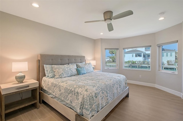 bedroom with ceiling fan, baseboards, wood finished floors, and recessed lighting