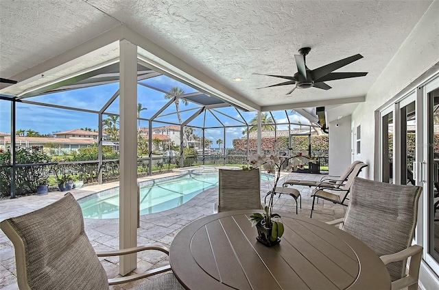 sunroom / solarium with a swimming pool, a wealth of natural light, and a ceiling fan