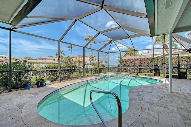 view of pool featuring a patio area, a lanai, and a pool with connected hot tub