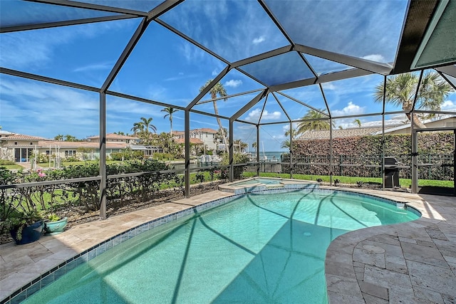 view of pool with a lanai, a patio area, and a pool with connected hot tub