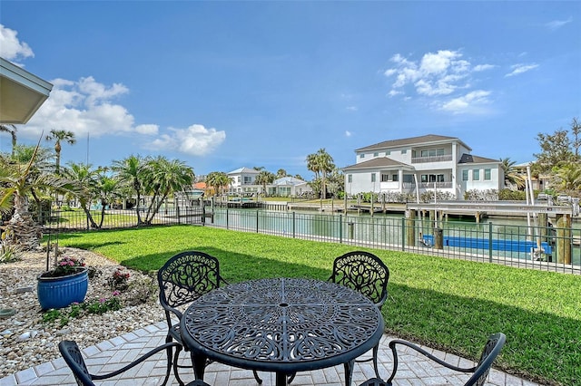 view of yard with a water view, a residential view, and fence