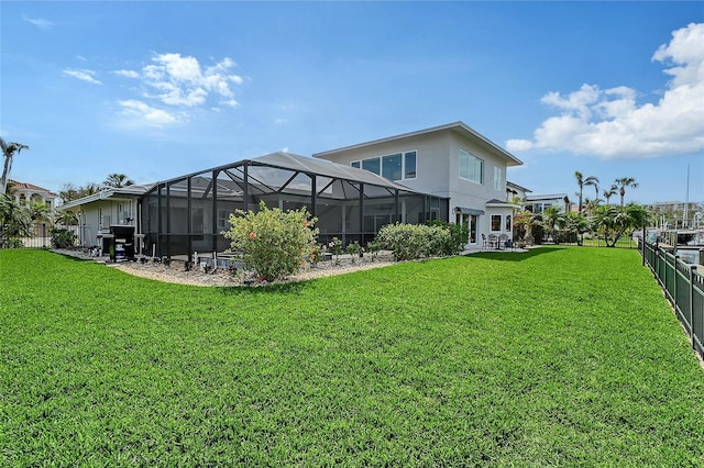 view of yard with a lanai and fence