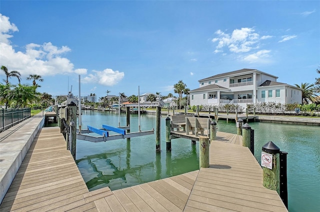 dock area with a water view and boat lift