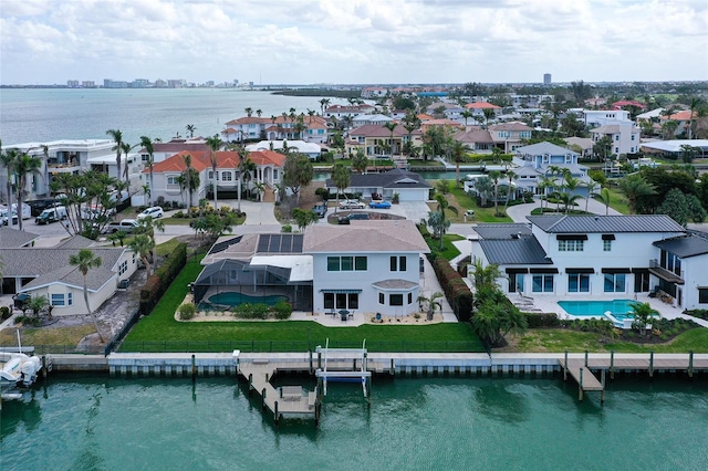 bird's eye view featuring a water view and a residential view