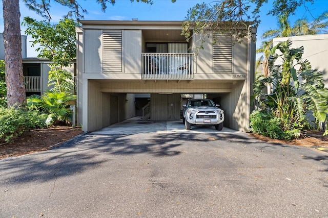 view of front of house featuring a carport and a balcony