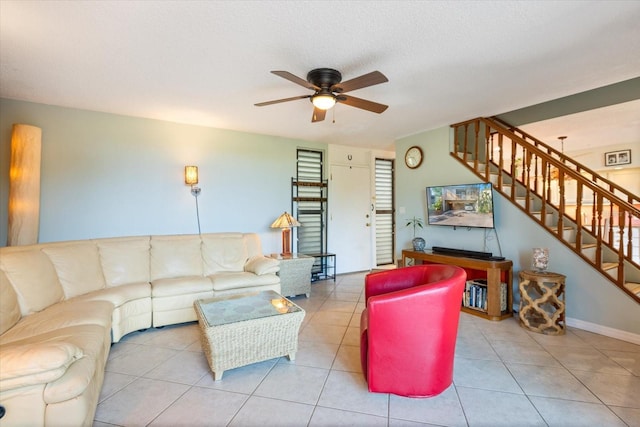 living room featuring light tile patterned flooring, a textured ceiling, and ceiling fan