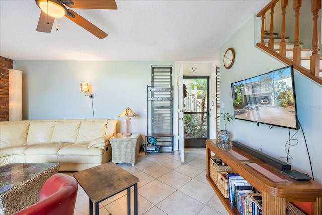 tiled living room with ceiling fan