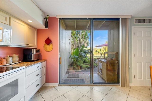 doorway with light tile patterned floors