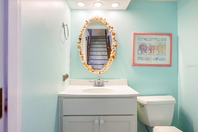 bathroom featuring vanity and toilet