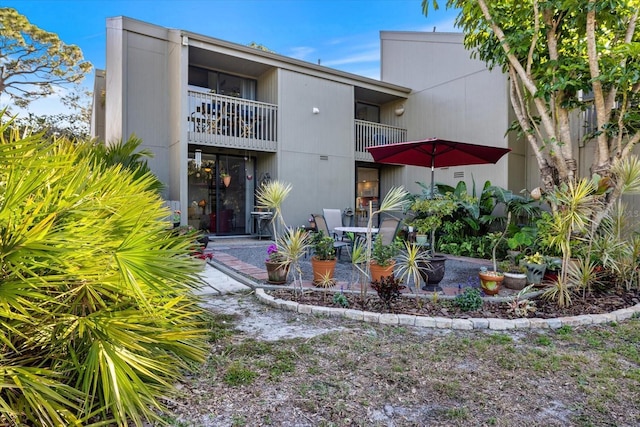 rear view of property featuring a balcony