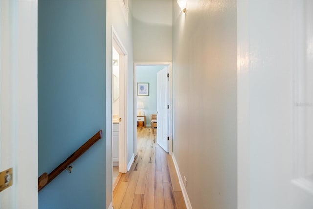 corridor with light hardwood / wood-style floors