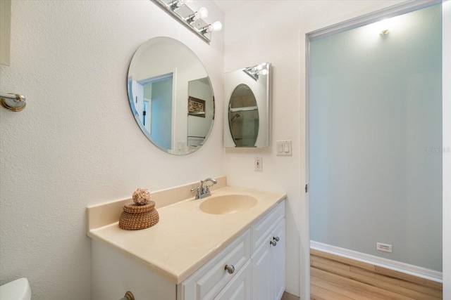 bathroom featuring vanity and hardwood / wood-style flooring