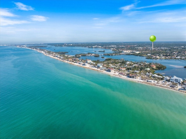 birds eye view of property with a water view and a beach view