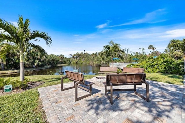 view of patio / terrace with a water view and a fire pit