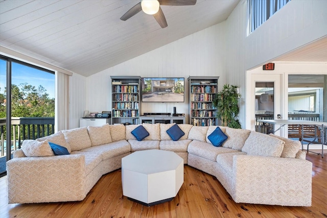 living room featuring ceiling fan, a healthy amount of sunlight, high vaulted ceiling, and wood-type flooring