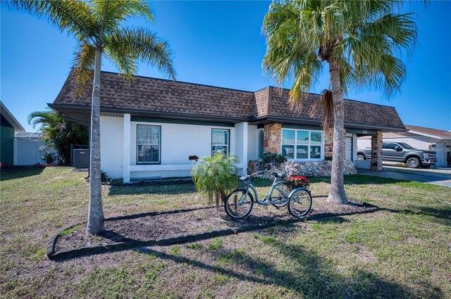 exterior space featuring a carport and a lawn