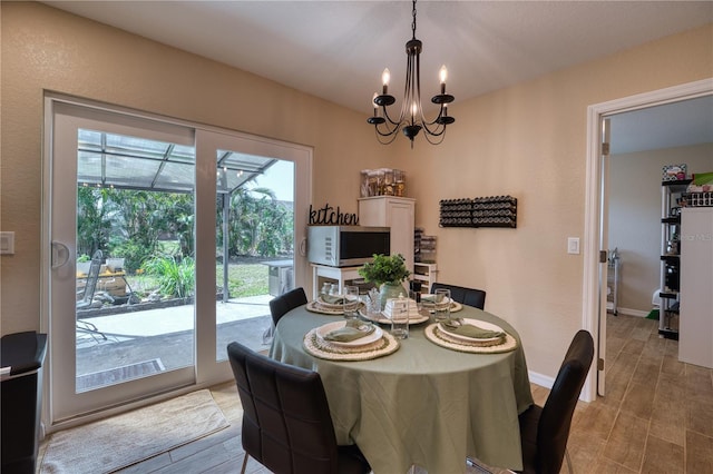 dining space featuring a notable chandelier and light hardwood / wood-style flooring