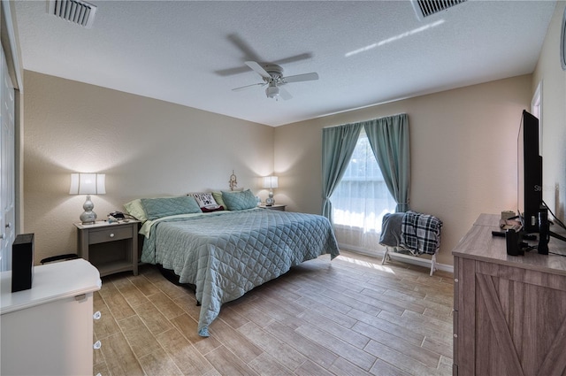 bedroom featuring a textured ceiling and ceiling fan