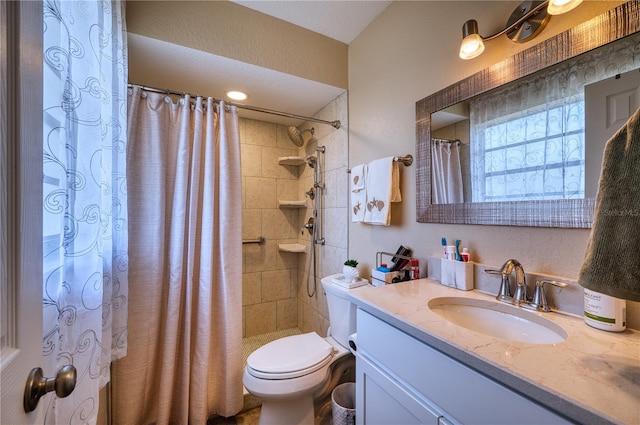 bathroom featuring vanity, toilet, and curtained shower