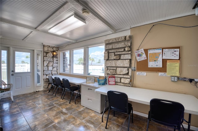 office with built in desk, wooden ceiling, and beamed ceiling