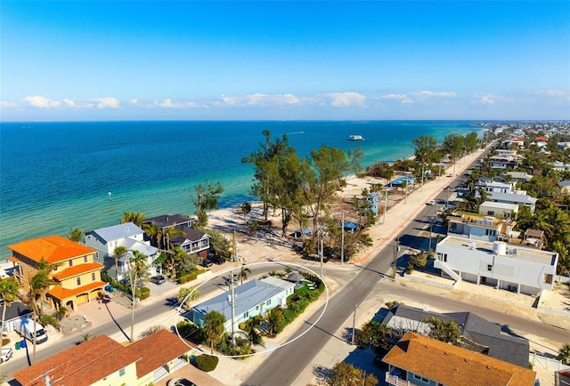 drone / aerial view featuring a residential view and a water view