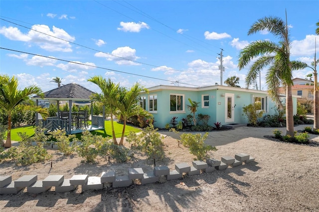 ranch-style home with a gazebo and a front lawn