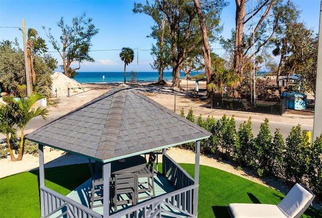 view of community featuring a water view, a gazebo, and a lawn