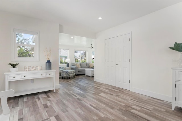 interior space featuring recessed lighting, light wood-style floors, and baseboards