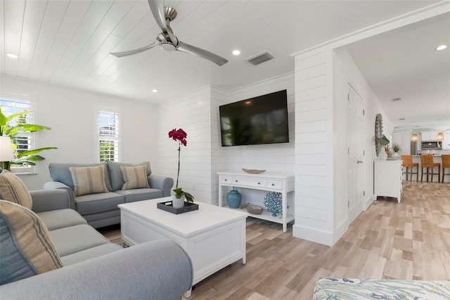 living room featuring wood ceiling, ceiling fan, and light wood-type flooring