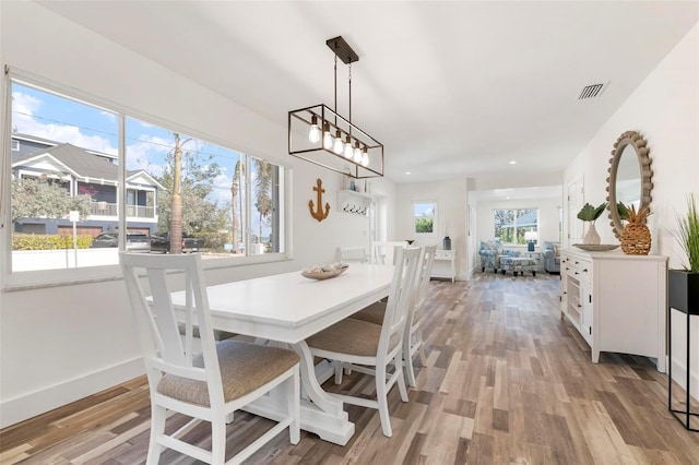 dining room with recessed lighting, light wood-style floors, visible vents, and baseboards