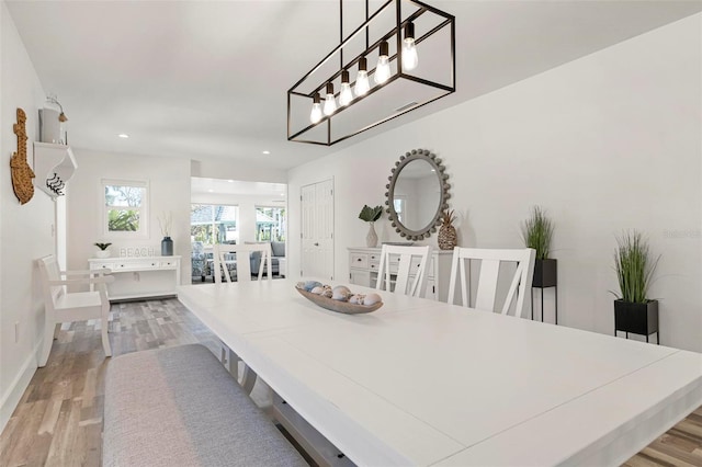 dining area with recessed lighting, baseboards, and light wood finished floors