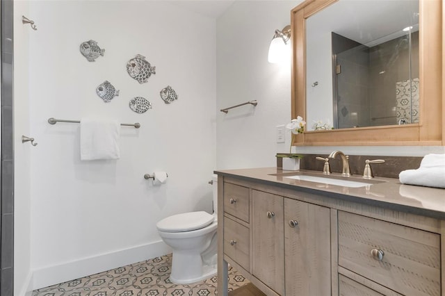 full bath featuring tile patterned flooring, baseboards, toilet, a stall shower, and vanity