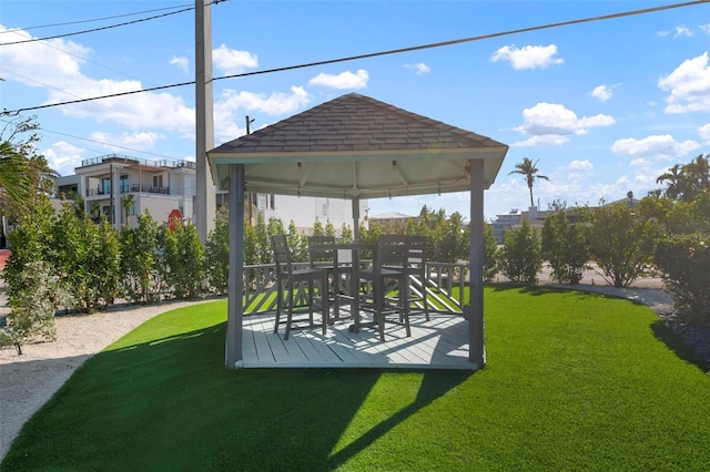 surrounding community with a deck, a gazebo, and a lawn