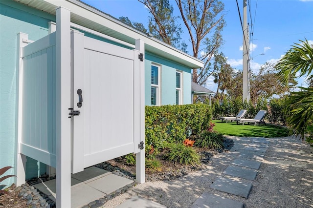 doorway to property with a lawn and stucco siding