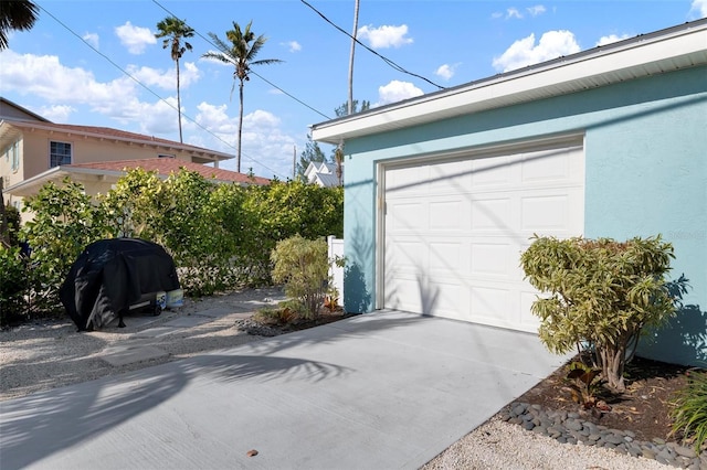 garage with concrete driveway