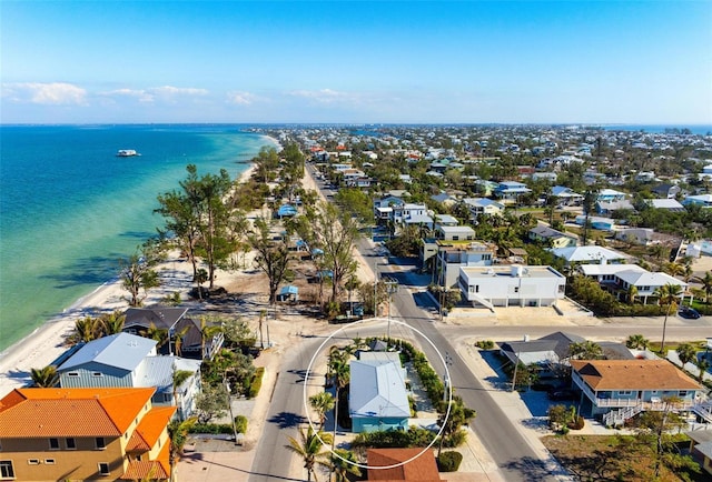 aerial view featuring a beach view, a water view, and a residential view