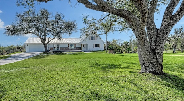 view of front of property featuring a garage and a front yard